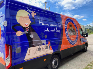 View of a small ambulance's interior, featuring a blue floor and organized medical supplies for emergency response.